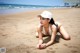 A woman laying on the sand on a beach.