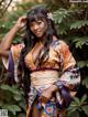 A woman in a kimono posing for a picture.