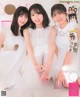 A magazine with three young women in white dresses.