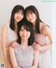 A group of three young women posing for a picture.