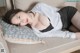 A woman laying on a couch with a pillow.