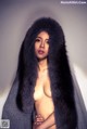 A woman in a fur coat posing for a picture.