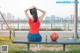 A woman sitting on a bench with a basketball.