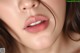 a close up of a woman's face with long brown hair